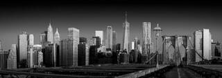 Empty boardwalk leading toward the Manhattan skyline, with a bridge framing the path and a calm, suspended city atmosphere.
