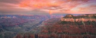 Bathed in the warm hues of sunset, the Grand Canyon stands majestically, offering a tranquil sanctuary where timeless beauty meets the soul's quest for solace.