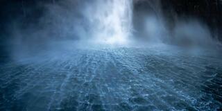The wind-torn water surface at the base of Stirling Falls where the cascade meets the fiord, long exposure, Milford Sound, New Zealand.