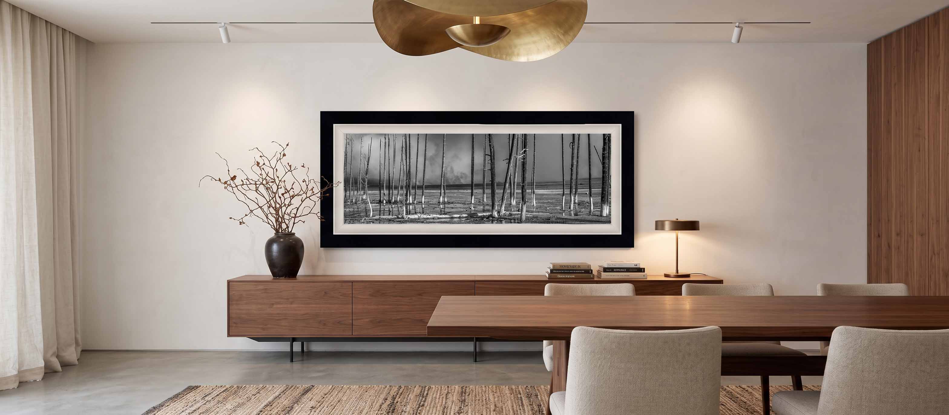All Is Not Lost shown as a framed black and white print above a walnut sideboard in a plaster dining room, in a Moda Satin Black moulding with a white linen liner