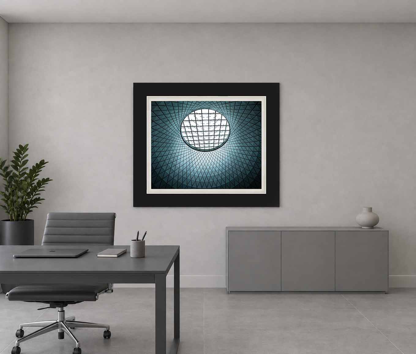 The Sky Reflector-Net oculus at Fulton Center seen from below, framed in black with a white linen liner above a credenza in a gray room