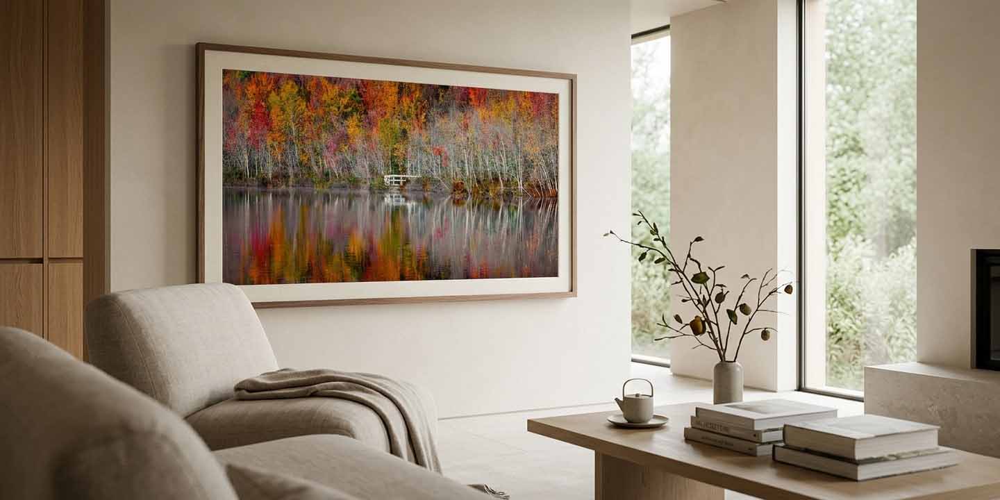 Autumn Stillness shown as a framed print above a chair in a plaster and oak living room, in a pale wood moulding with a cream linen liner
