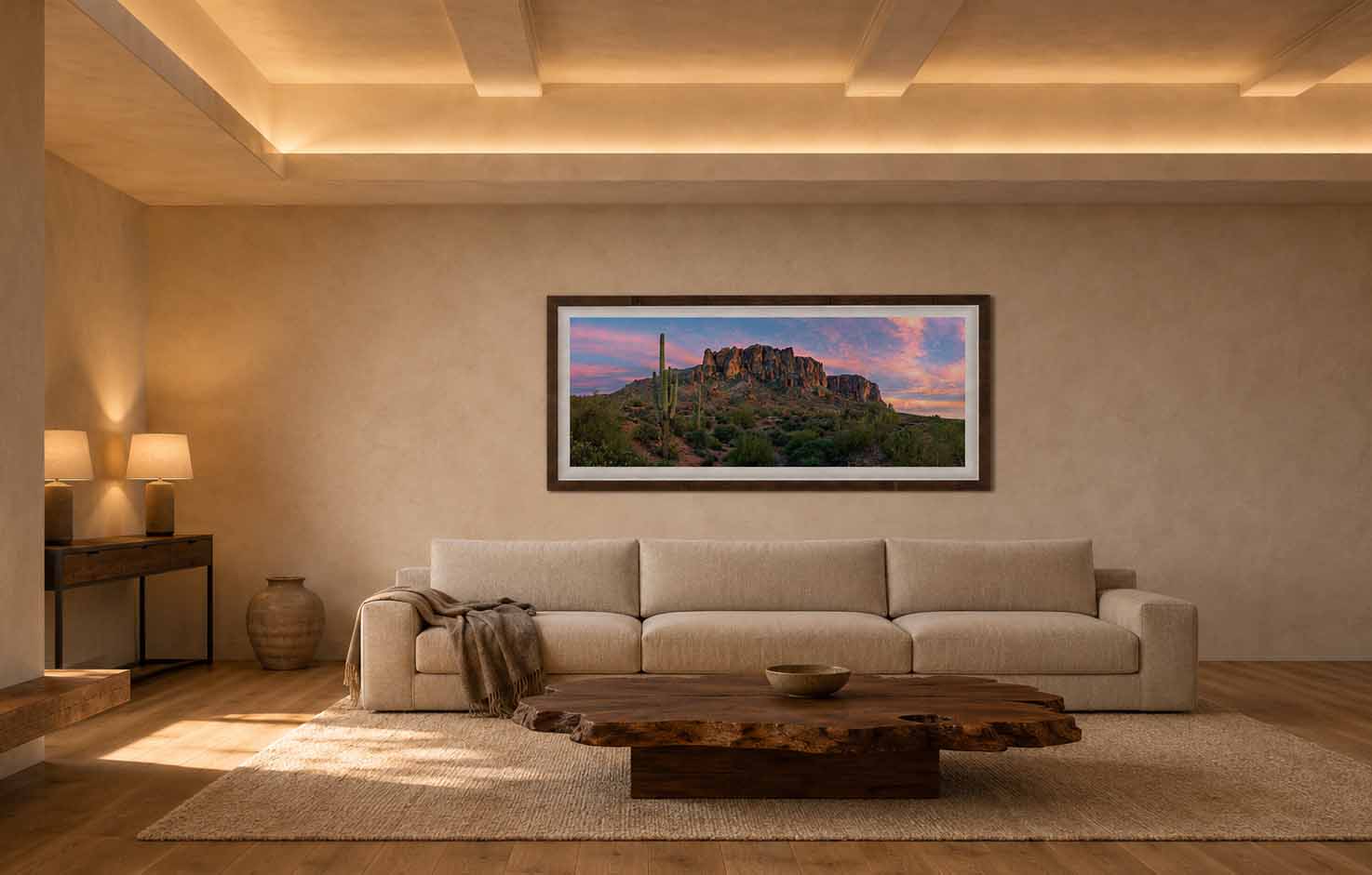 Mountain of Riches displayed above a long oatmeal sofa in a warm plaster living room with a coffered ceiling, framed in Tabacchino Dark Ash with a white linen liner