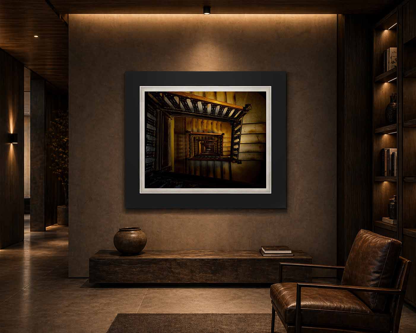 An old New York stairwell seen from above down its open well, framed in black with a white linen liner above a stone bench in a dark room