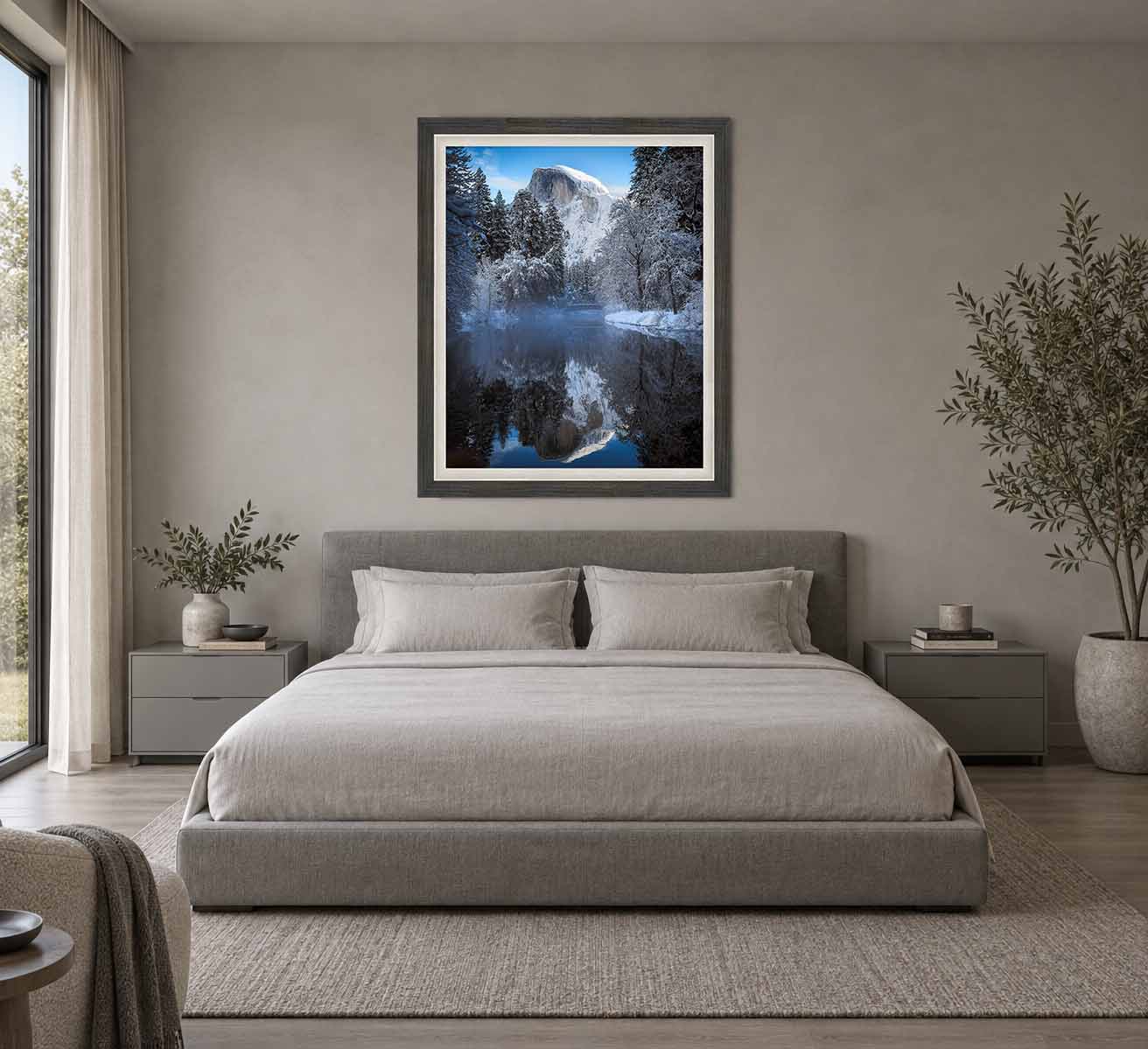 Half Dome and the Merced River after a winter storm, framed in gray with a white linen liner above a bed in a pale bedroom