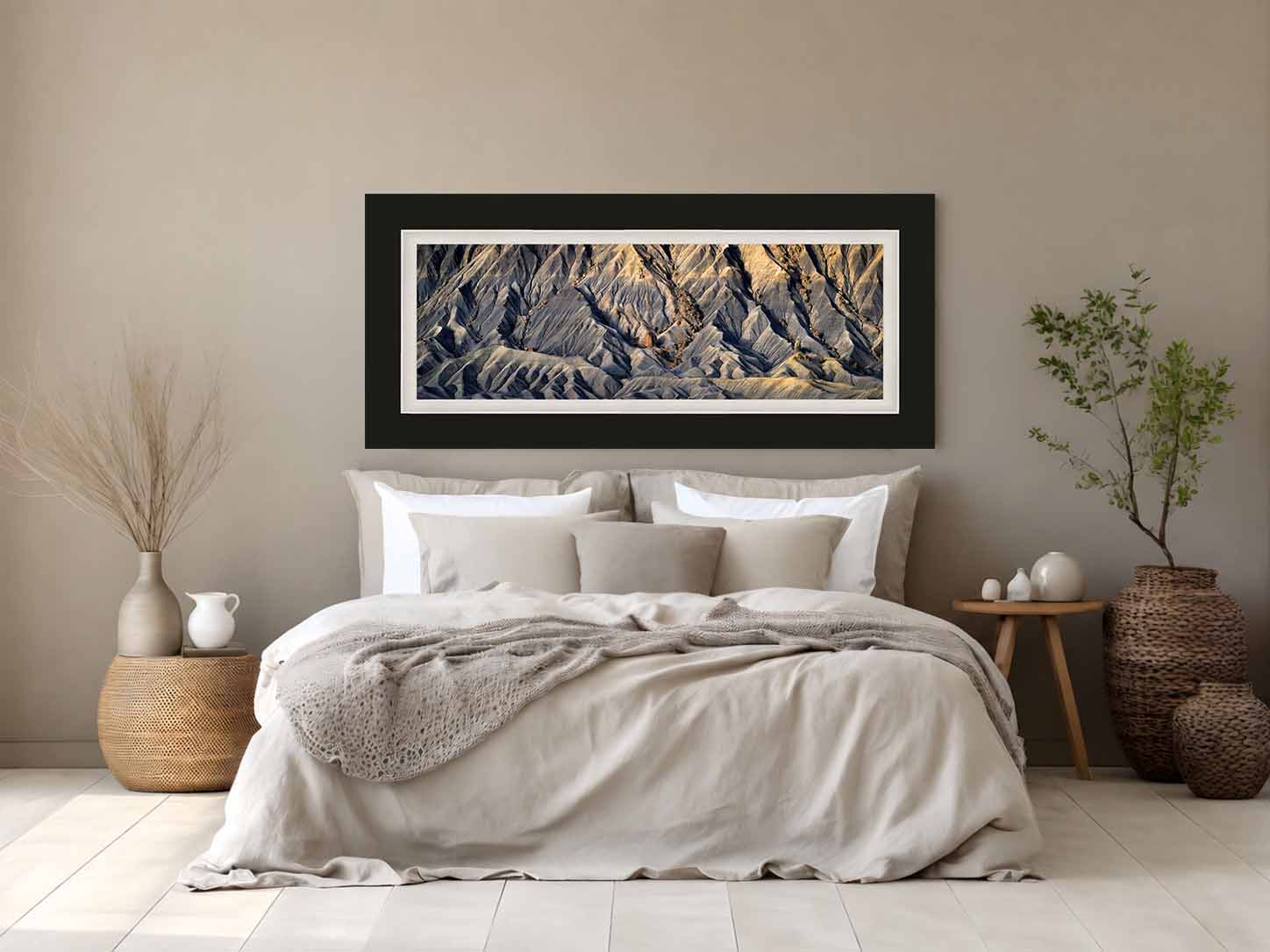 Eroded blue-gray badlands at Factory Butte, Utah, framed in flat black with a white liner above a bed with pale linen in a quiet guest room.