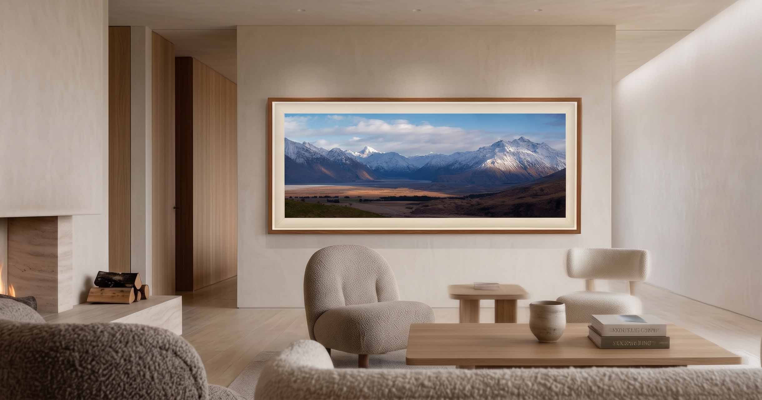 The Kingdom shown as a framed print on a plaster wall in a warmly lit living room with a travertine fireplace, in a walnut moulding with a cream linen liner