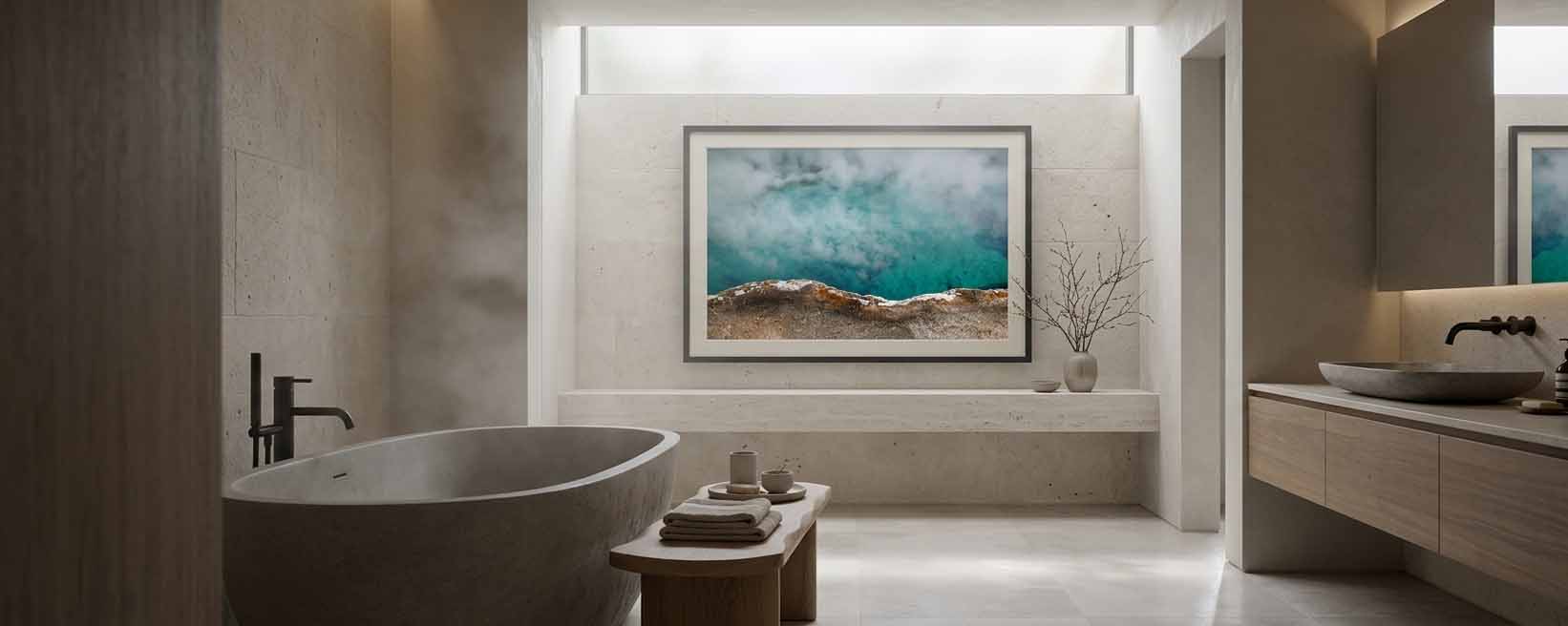 Turquoise Spring shown as a framed print above a stone bench in a limestone bathroom, in a slim grey moulding with a white linen liner
