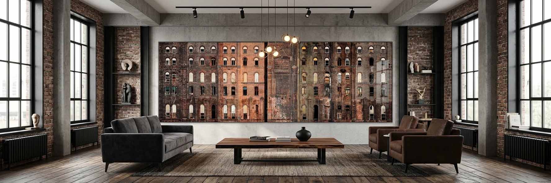 The Domino Sugar Refinery print shown as a wide panorama above a sofa in an industrial loft with exposed brick and tall windows.